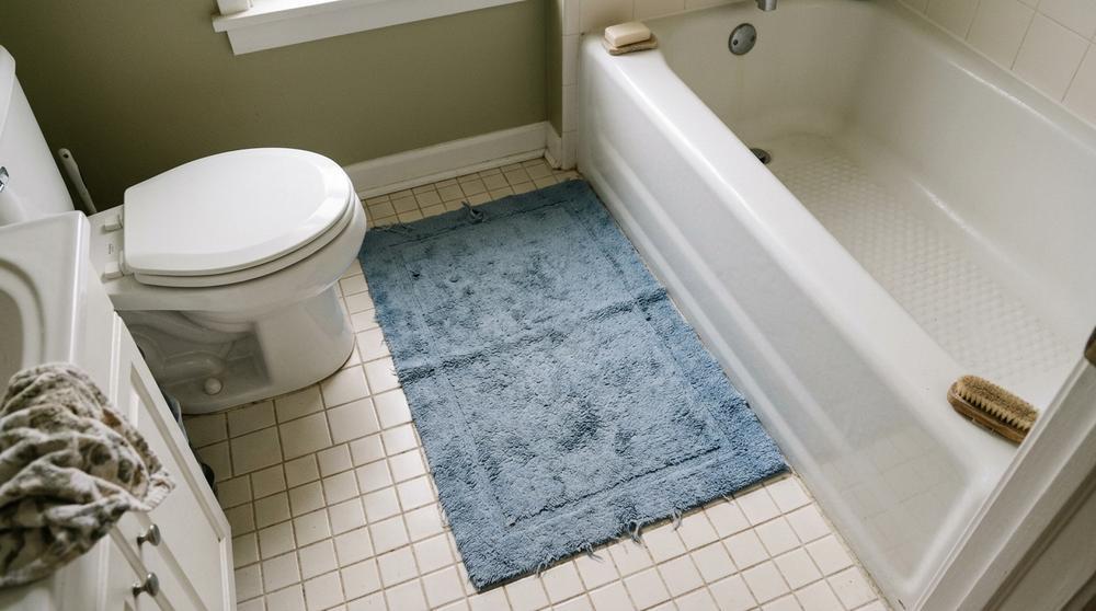 Bathroom floor mat that makes home feel lived-in - remove before selling